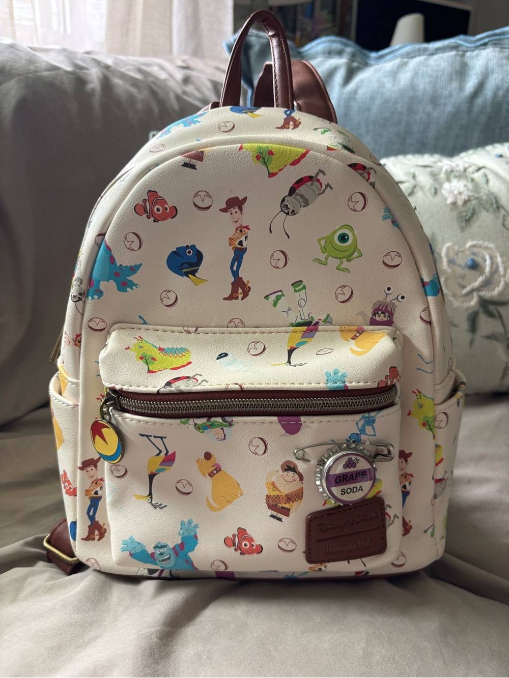 Loungefly Pixar Mini Backpack - Cream with your favorite Characters